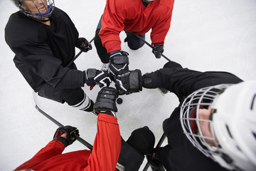 Fototapeta na wymiar Above view background of hockey team huddling ready to start match on skating rink, copy space