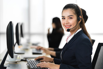 Beautiful businesswoman customer support services working with headset and computer at call center
