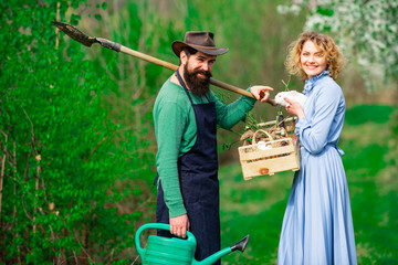 Couple of farmers walking in agricultural field. Couple of farmers seedling sprouts in the garden.