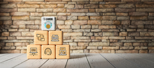 Fototapeta na wymiar cubes with e-learning symbols in front of a brick wall