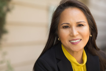 Portrait of a mature Asian woman in a business suit.