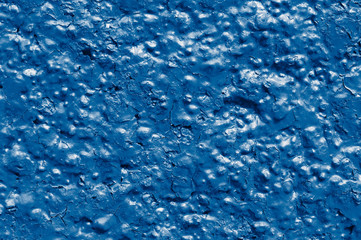 Red wall with decorative plaster.  toned  in classic blue trendy color of the year 2020