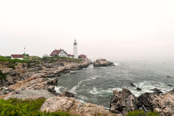 Fototapeta na wymiar The Portland Head Lighthouse, located on the coast of Maine, in the fog.
