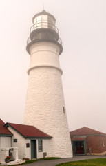 Close up of the Portland Head Lighthouse in dense fog.