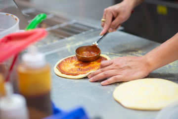 Worker making pizza in the restuarant