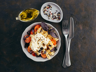 Pasta fusilli with cherry, mozarella and basil