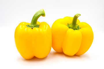 Double yellow pepper on white background