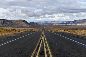 Road into the rocky high desert landscape of the Colorado plateau near the border of Arizona and...
