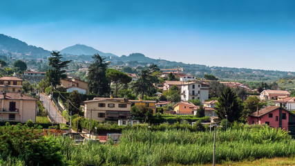 Fototapeta na wymiar Small town on the background of mountains in Italy
