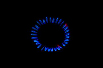 blue flame of a burning burner in the dark background