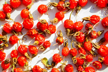 Many rose hips are dried in the sun macro close up. Healthy natural vitamin berries for tea....