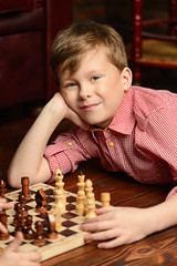little boy playing chess