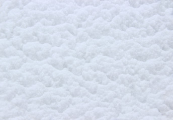 The sloping wooden shield is covered with fresh snow sliding down.