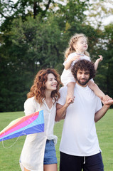 Fototapeta premium Happy young family in the park