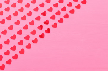 Valentines day concept. red hearts over wooden pink background. Flat lay composition