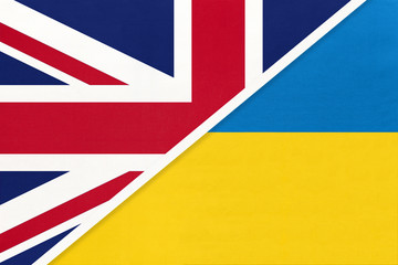 United Kingdom vs Ukraine national flag from textile. Relationship between two european countries.