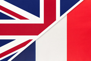 United Kingdom vs France national flag from textile. Relationship between two european countries.
