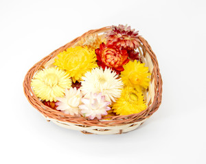 Fototapeta na wymiar A heart-shaped basket full of dried flowers