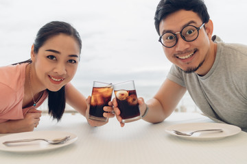 Lover couple having a date at the restaurant on the beach.