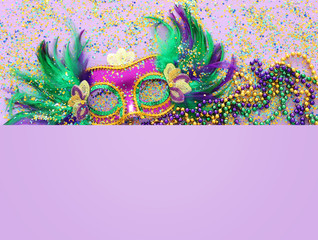 Holidays image of mardi gras masquarade venetian mask over purple background. view from above