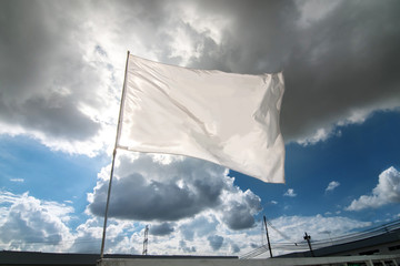 White flag waving over the cloudy sky
