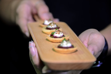 mini cracker canepe appetizer serve on wooden platter