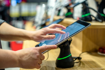 Girl chooses a mobile phone in the store