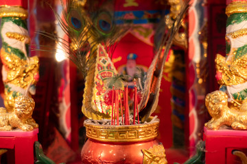 Red incense stick in a golden incense burner in the Chinese temple. Is a wish to pray for the sacred things of the Chinese people.