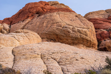 Low angle landscape of large white and red rock formations or hills at Red Rock Canyon Conservation Area in Las Vegas, Nevada