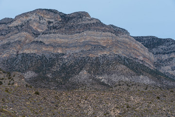 Low angle landscape of black and grey barren hillsides at Red Rock Canyon Conservation Area in Las Vegas, Nevada