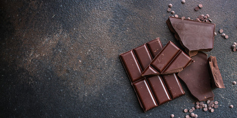 chocolate (delicious cocoa dessert, pieces of sweets) menu concept. food background. top view. copy space