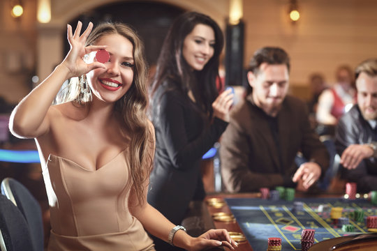 Happy smiling girl smiling at the roulette in a casino Stock Photo | Adobe  Stock