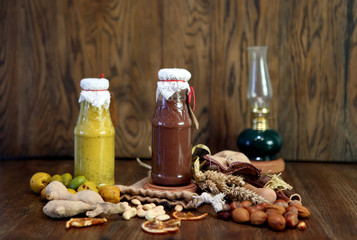 yellow and chocolate Smoothie at the bottle Colorful drink, milk shake in bottle with fresh vegetables and superfoods on a wooden background. Healthy, clean eating, vegan, vegetarian, detox
