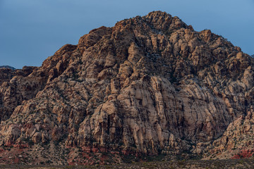 Low angle landscape of dark stone mountain on a cloudy day at Red Rock Canyon Conservation Area in Las Vegas Nevada