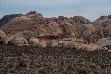 Landscape of white and red rock formations or hill on a cloudy day at Red Rock Canyon National Conservation Area in Las Vegas, Nevada