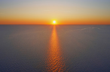 Fototapeta na wymiar Sunrise over the sea, clear blue sky