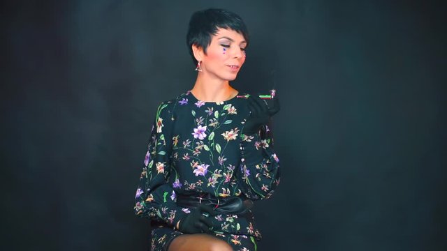 Portrait of a woman smoking a pipe with marijuana.