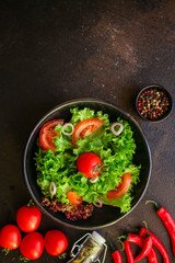 Healthy salad, leaves mix salad (mix micro greens, cucumber, tomato, chili pepper, other ingredients). food background. copy space