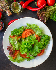 Healthy salad, leaves mix salad (mix micro greens, cucumber, tomato, chili pepper, other ingredients). food background. copy space