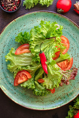 Healthy salad, leaves mix salad (mix micro greens, cucumber, tomato, chili pepper, other ingredients). food background. copy space