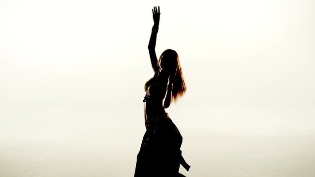 Woman dancer dancing in silhouette on white background