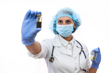 Woman in protective uniform holding different ampoules isolated on white