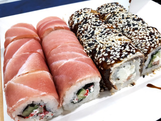 Close-up of a set of sushi with soy sauce on an abstract surface