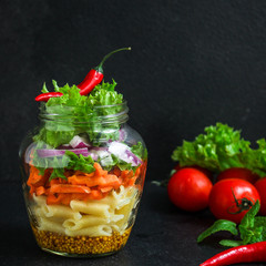 healthy salad in a jar (vegetable snack pasta salad) menu concept. food background. top view. copy space