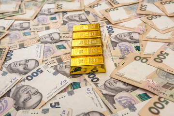 stacks of gold bars on ukraine moneu uah . top view