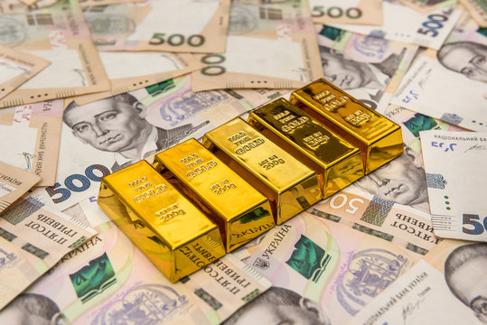 stacks of gold bars on ukraine moneu uah . top view