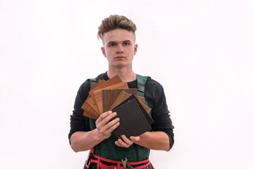 Man in coverall showing wooden sampler isolated on white