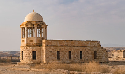an ancient franciscan catholic chapel being restored near the baptismal site on the jordan river with a byzantine era monastery in the background