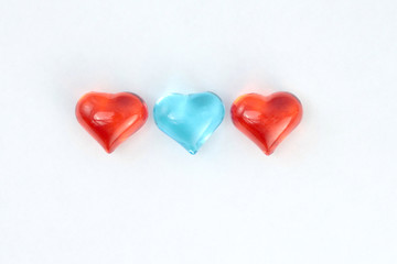 Blue and red glass hearts  on white background. Stock photo for Valentine's Day with empty place for text. For web, print, cards, invitations, wallpaper.