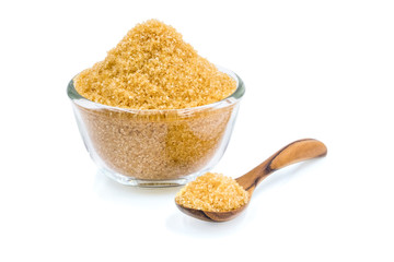 Close-up of Brown cane sugar in glass bowl with wooden spoon, Raw natural, Organic cane sugar isolated on white background with clipping path.